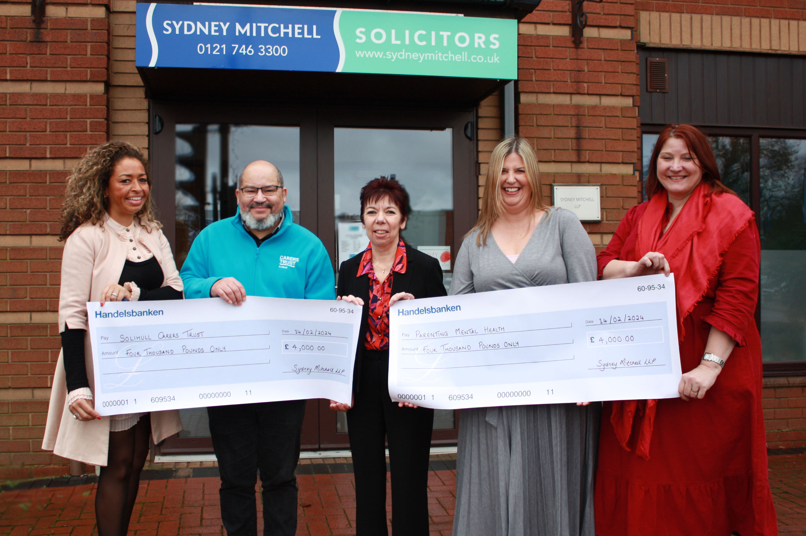 Sydney Mitchell LLP present cheques to Carers Trust Solihull and Parenting Mental Health